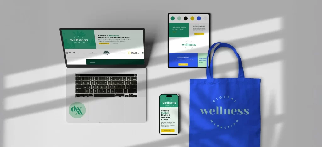 A bright blue canvas bag, tablet, and cell phone displaying Digital Wellness Marketing's branding.